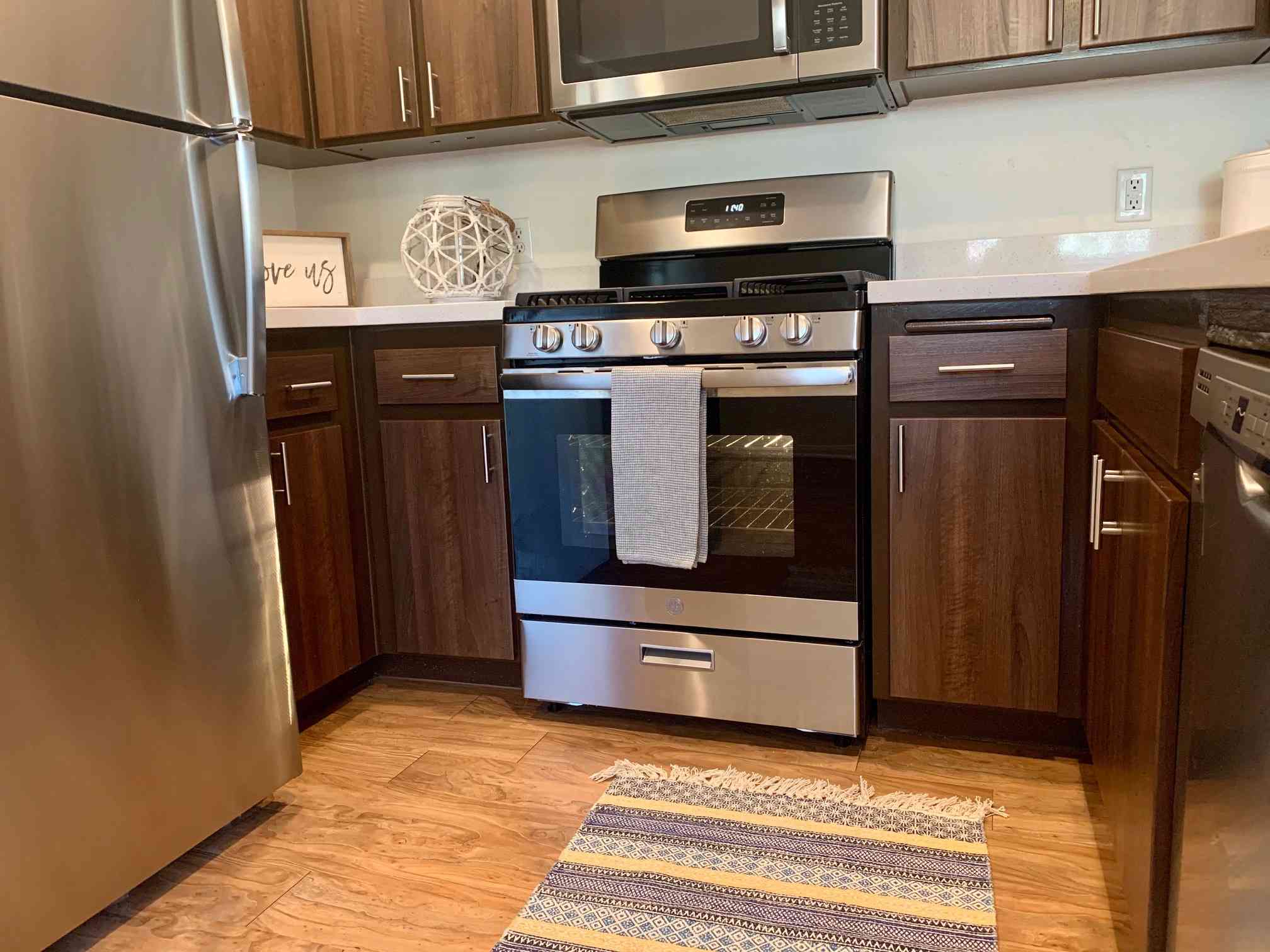 brown cabinet stainless steel appliances