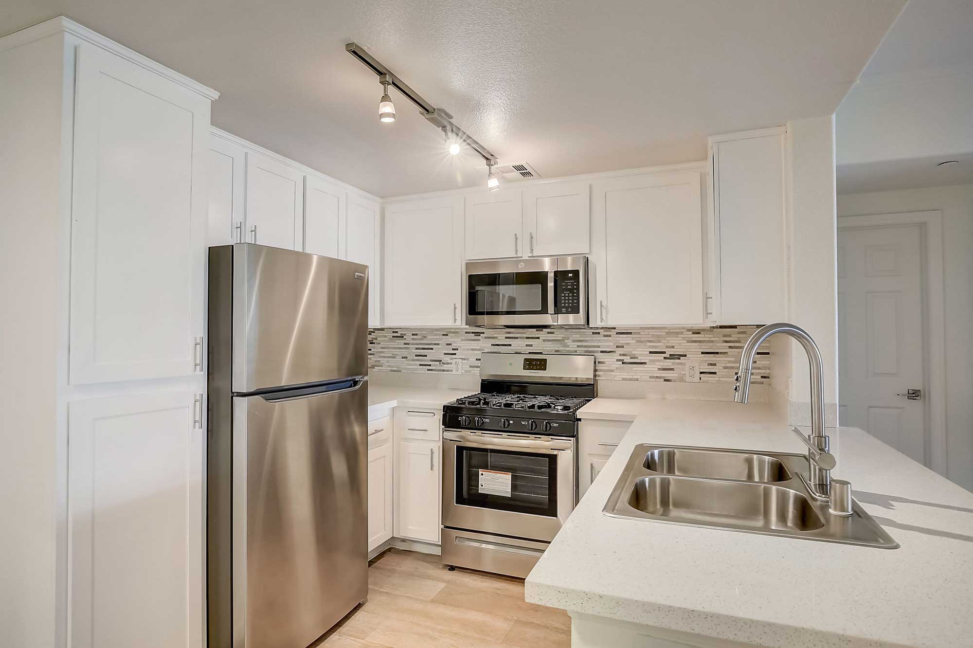 ritiro apartments white cabinet kitchen with stainless steel appliance package
