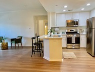 Ritiro Apartments white cabinet kitchen livingroom hallway