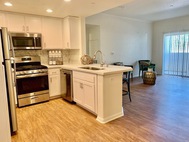Ritiro Apartments white cabinet kitchen spacious livingroom view