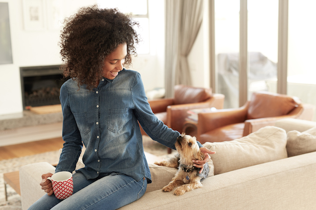 Woman and Dog sitting on a couch